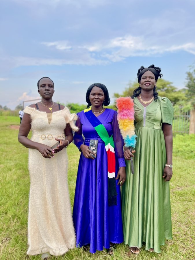 Three women in elegant gowns representing their communities at Peace Cultural Day